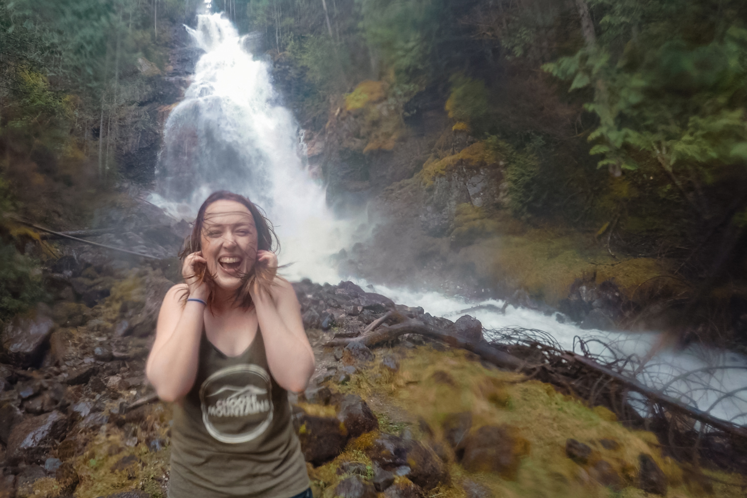 Woman holds hair in front of Kay Falls