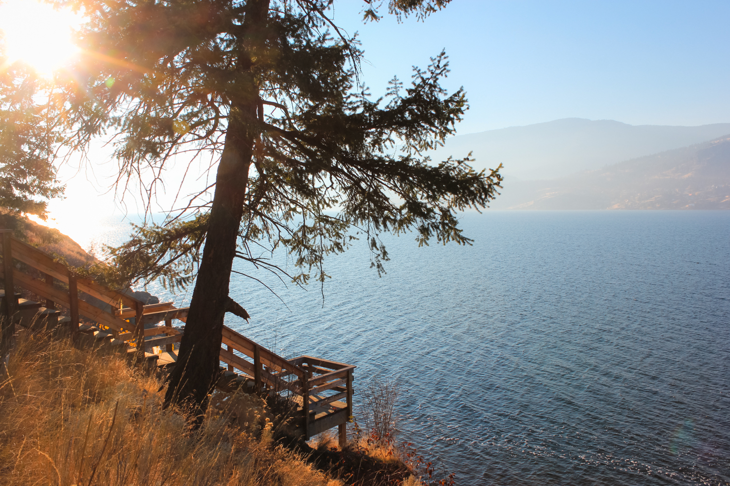 A wooden staircase leads towards Okanagan lake. Taken at sunset.