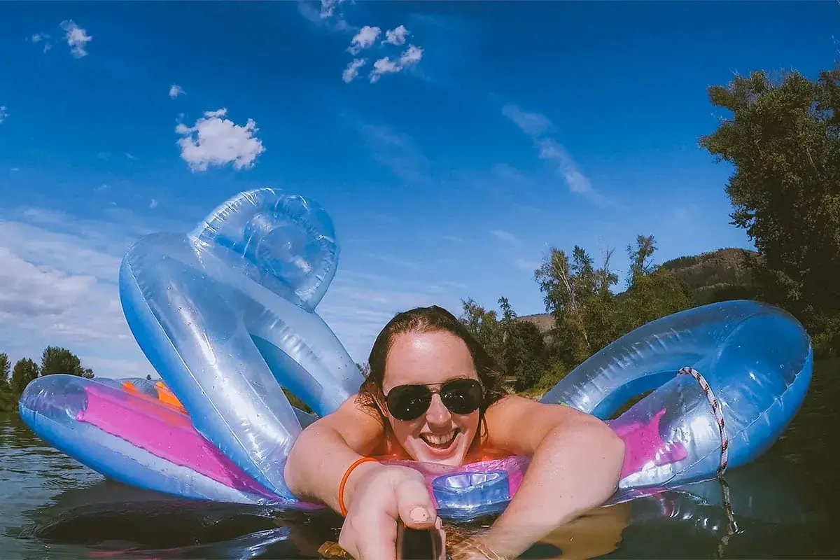 Selfie of a women laying on a floatie in the Enderby River.
