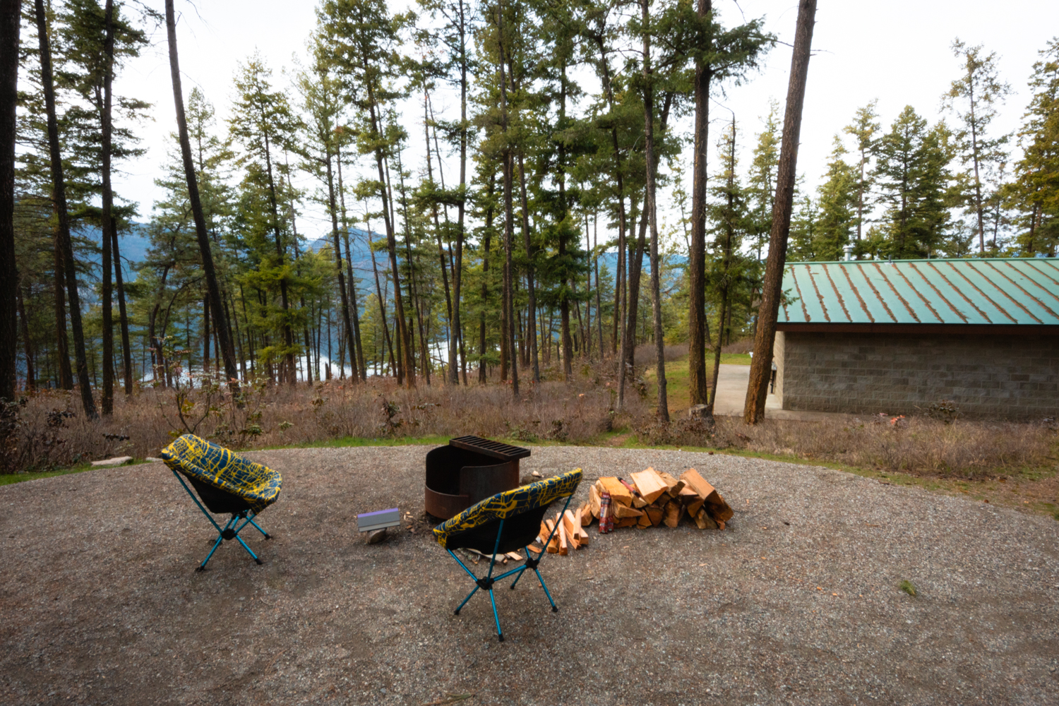 Chairs set up around a campfire pit at a campsite at Ellison campground