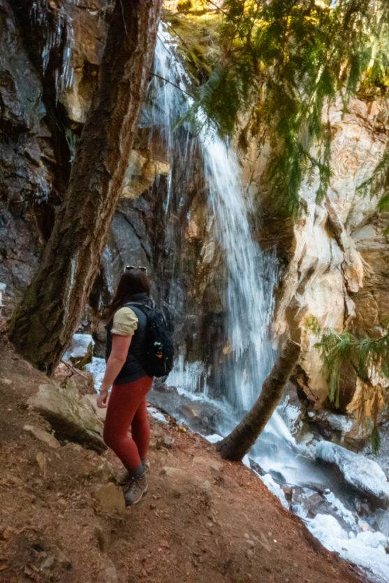 Women standing in front of Cosens Bay Falls in the spring