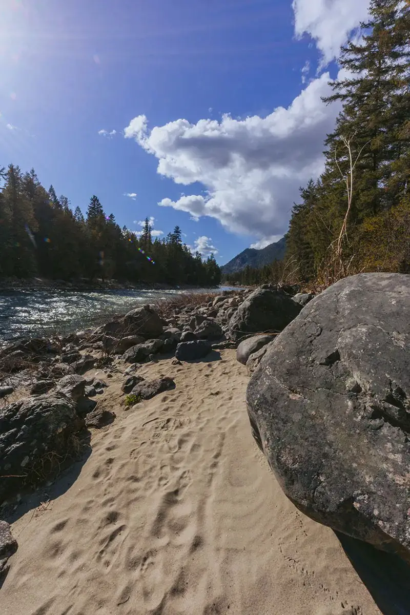 Sandy beach next to a river on a sunny day in BC