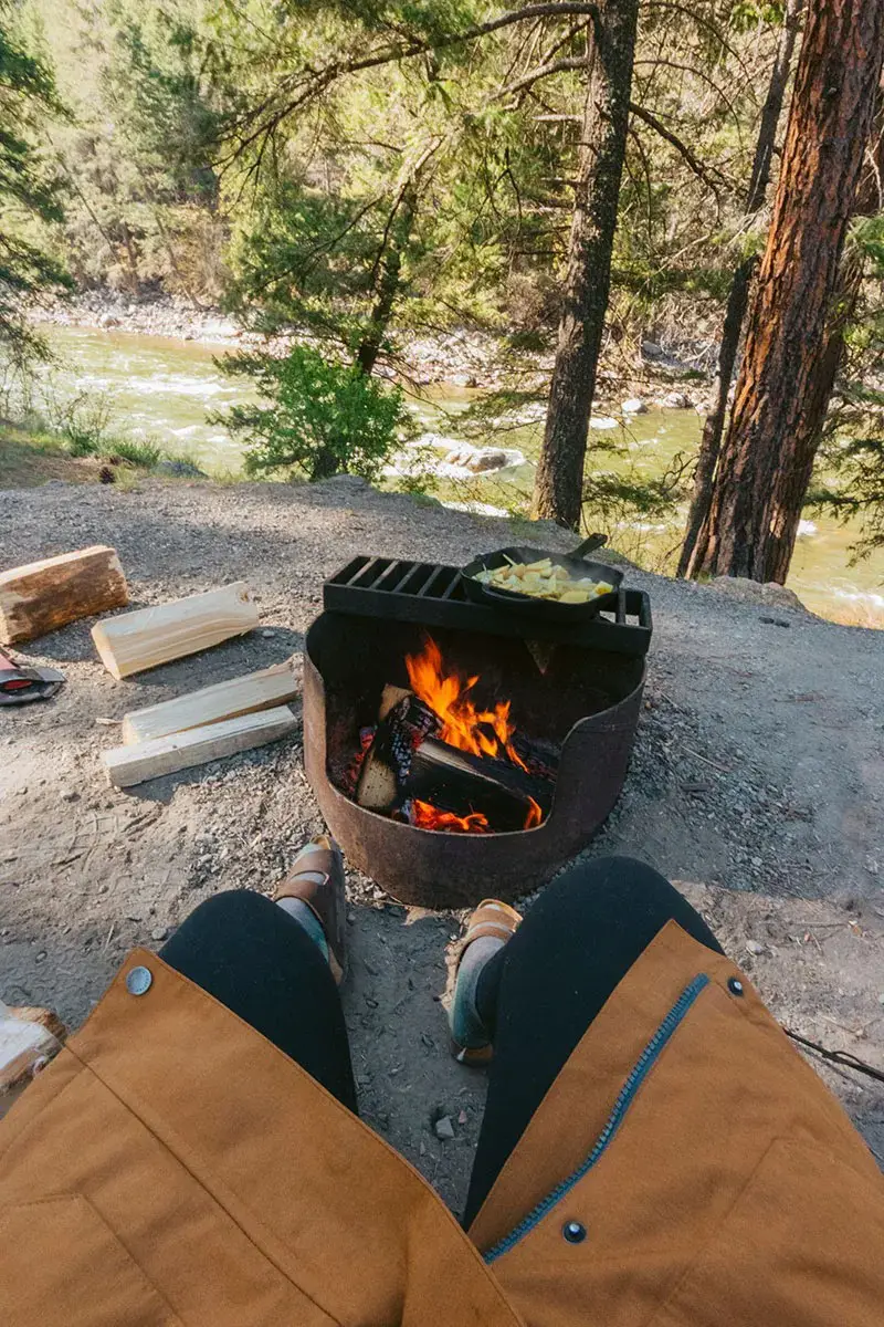 Woman's feet next to a small campfire