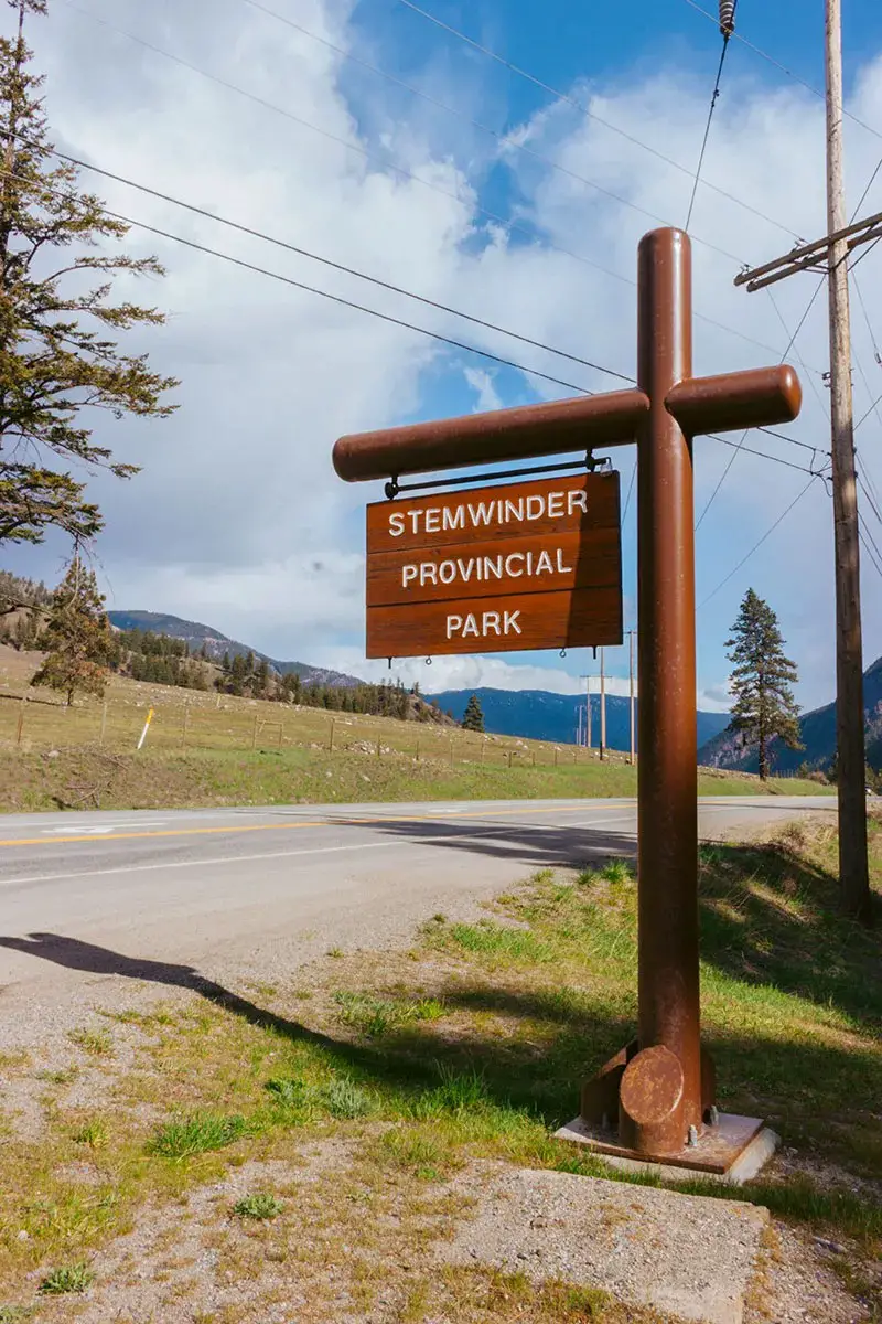 Wooden park sign at Stemwinder Provincial Park on the side of Highway 3