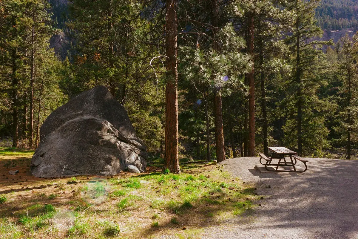 Campsite with a boulder and picnic table