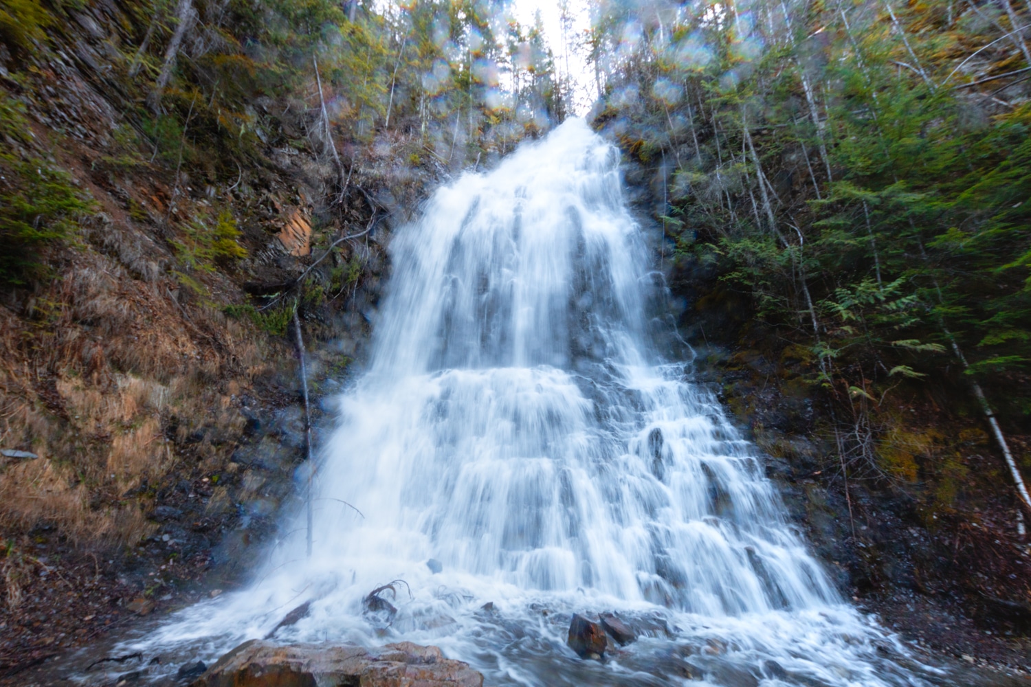 Base of Ione Falls. The lens is covered in water droplets, obscuring the photo.