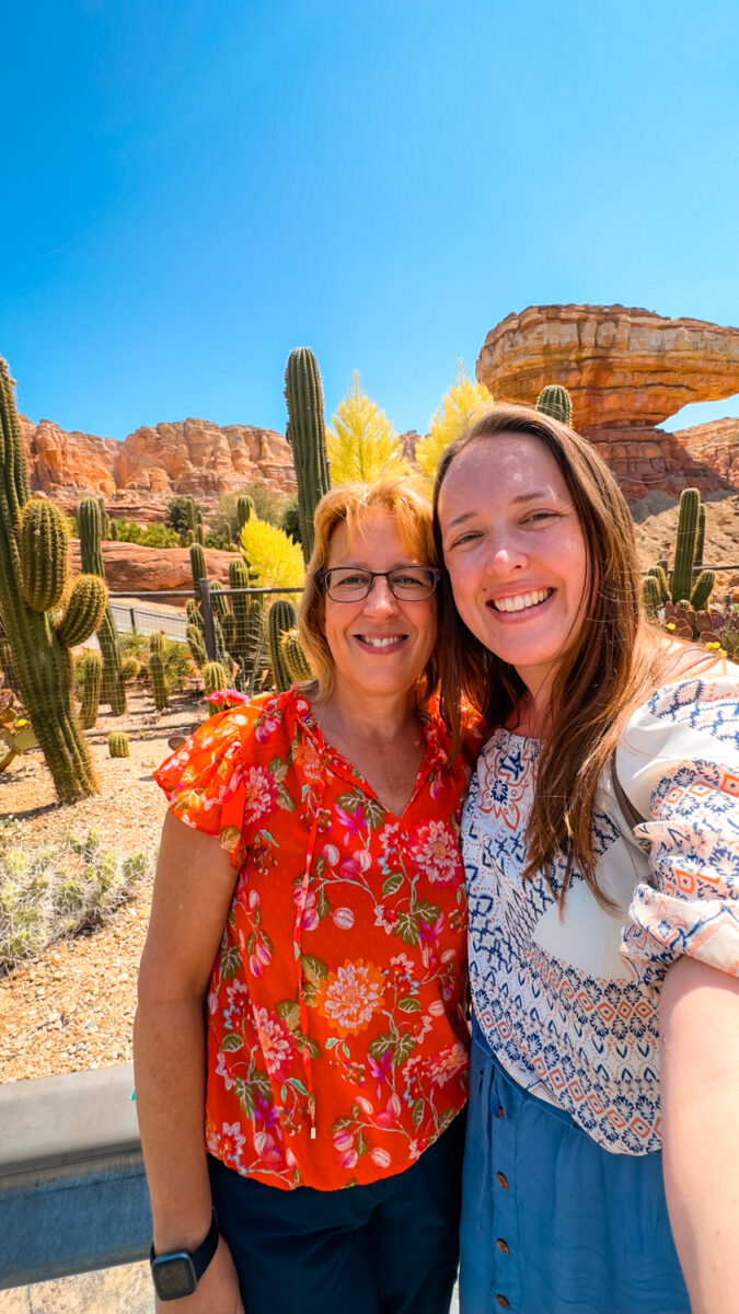 Selfie of two women in front of the cacti in front of Radiator Springs Racers in California Adventure