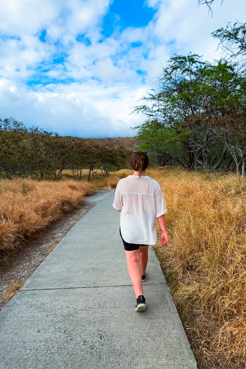 Woman walks along the flat crater bottom of Diamond Head.