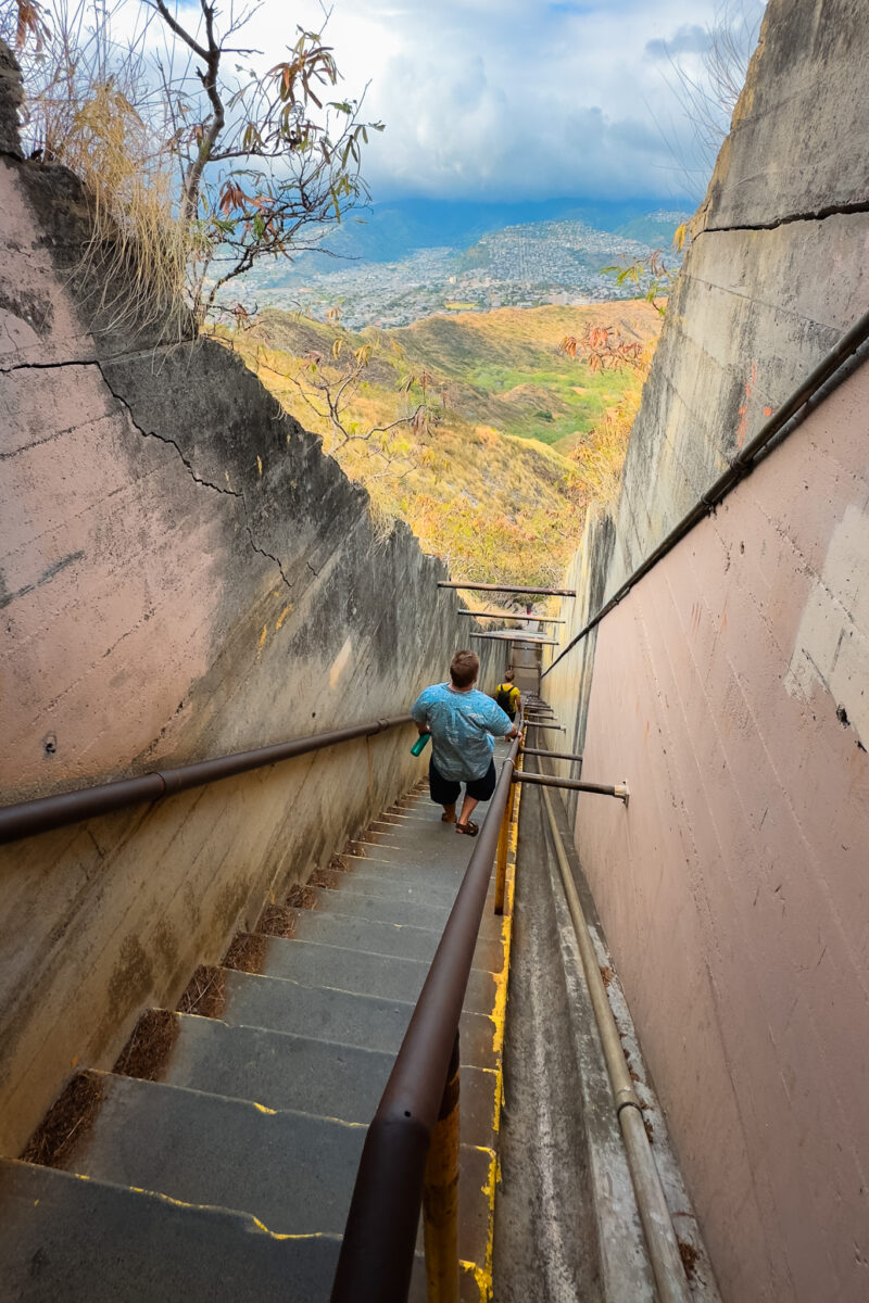 Man walks down a steep set of stairs at Diamond Head.