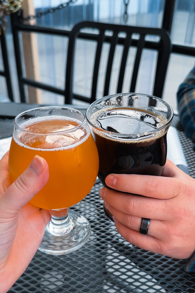 Cheersing beer glasses at Buffalo Rouge Brewing in Kelowna.