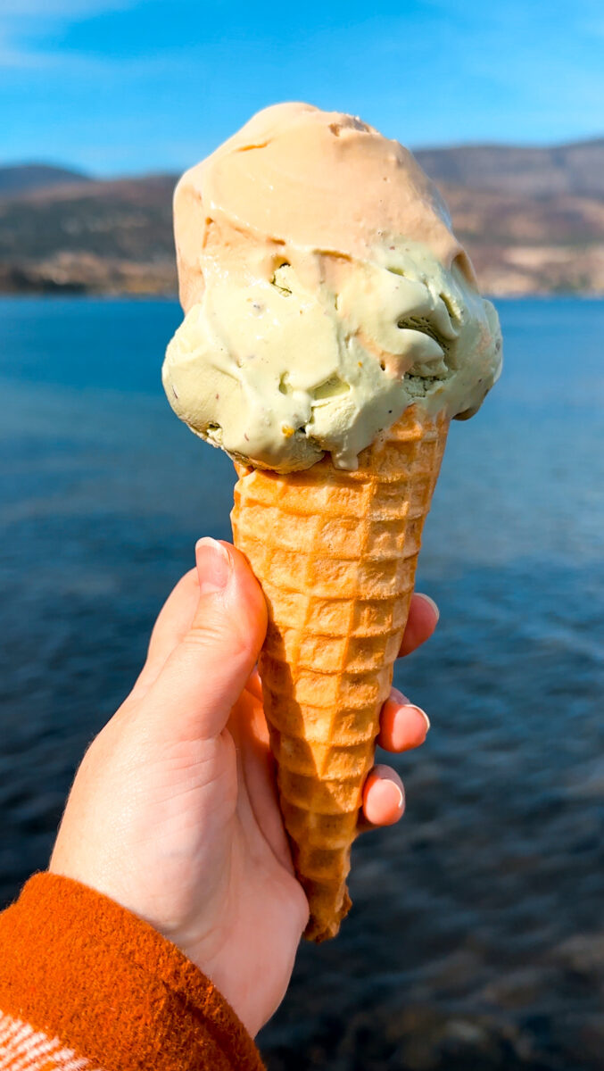 Ice cream cone from Parlour Ice Cream in Kelowna with Okanagan Lake in the background.