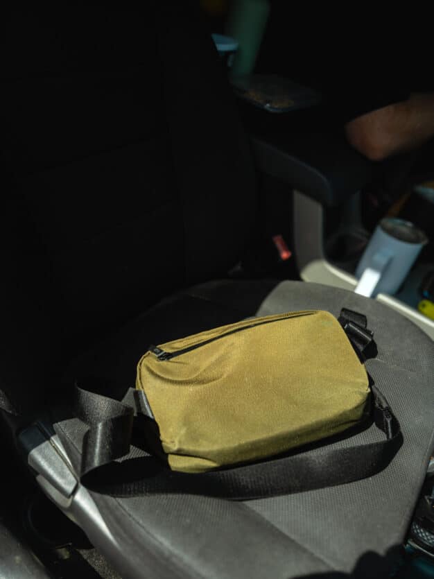 The ALPAKA Flight Sling sitting on a car seat