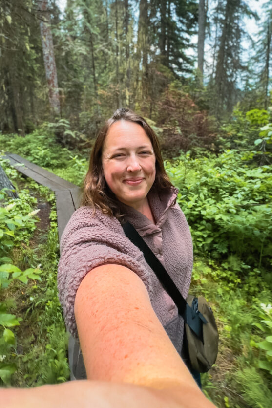 Woman wearing the ALPAKA flight sling on a hike with boardwalks
